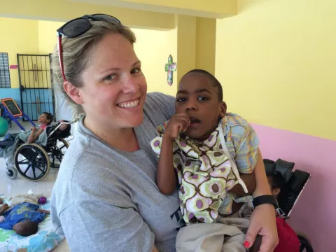 a woman holds a child