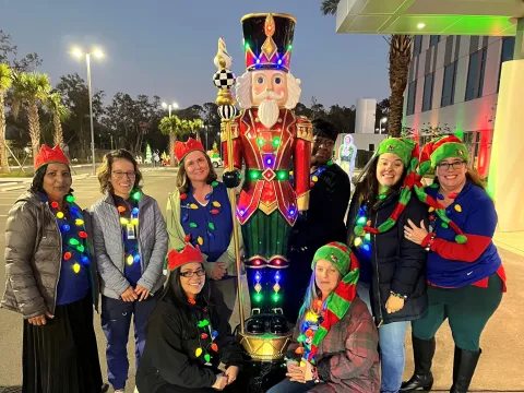 AdventHealth Riverview team members celebrate Lighting the Way, a drive through holiday event supporting ECHO.