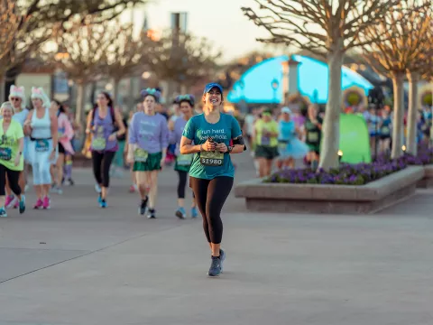 Woman running runDisney Princess 10k runner at Epcot.