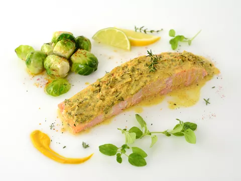 Herb-crusted salmon filet with Brussels sprouts and herb garnish