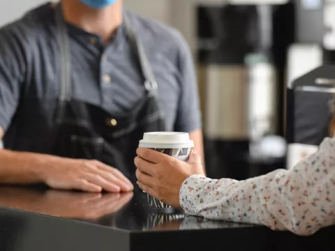 Barista serving coffee