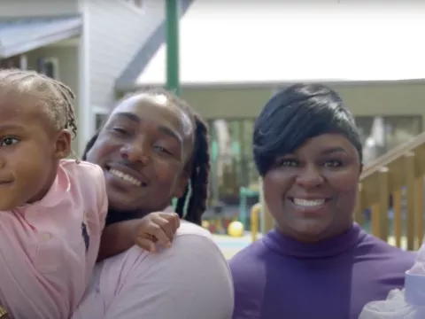 A family of four smiling