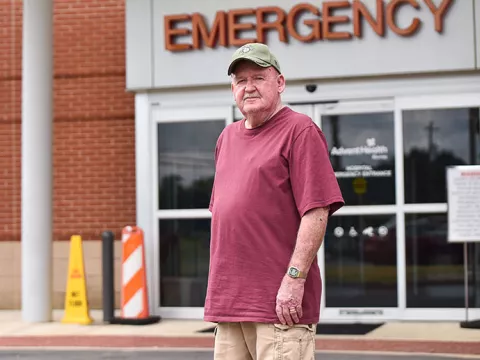 man stands in front of emergency department after suffering a stroke