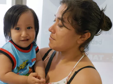 a child being held by a woman