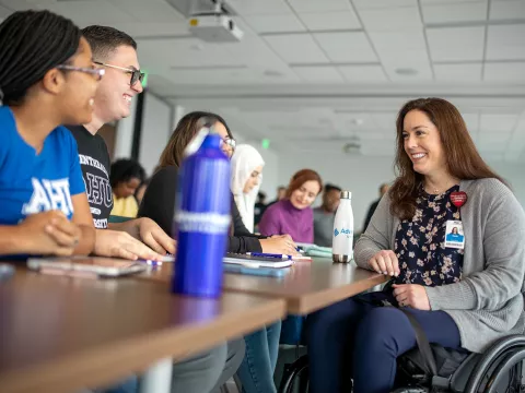 An AdventHealth University teacher talking with students.