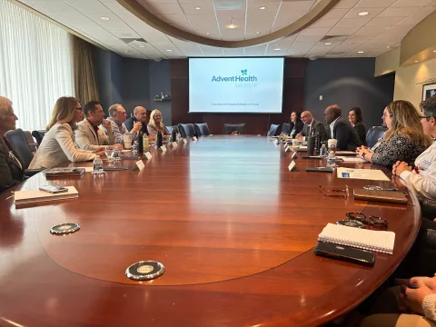 Pictured right leaning on the table: Abel Biri, AdventHealth Waterman CEO, emphasizes the hospital's dedication to quality care, community support and economic contributions in Lake County.