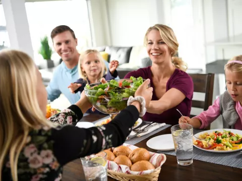 Family enjoys meal together at the dinner table