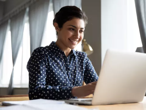 A woman using a laptop computer. 