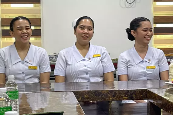 Filipino nurses sitting at a table