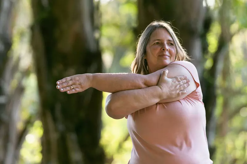 A woman stretching her arms outdoors
