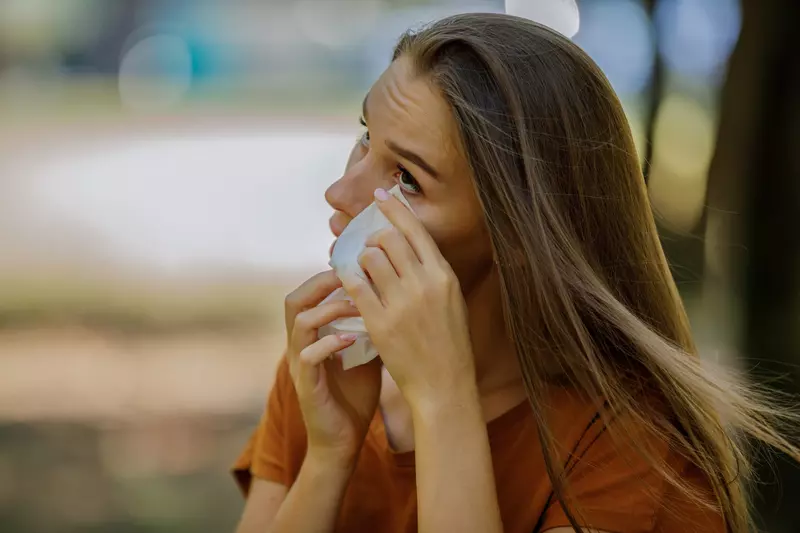 A Women Cleaning Her Eye with a Tissue.
