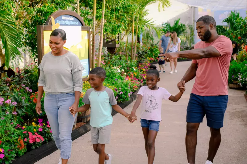 A Family Walks the Butterfly Garden at Epcot
