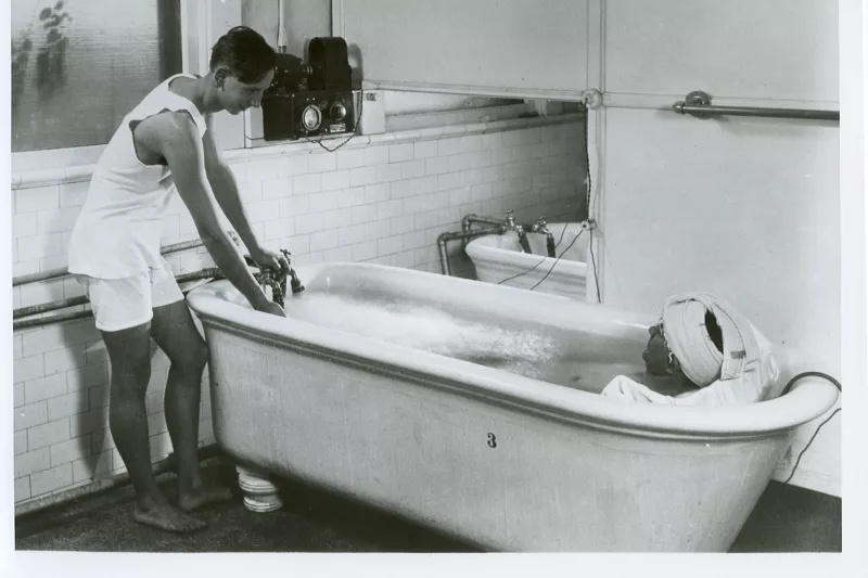 Man with a patient in a hydrotherapy tub.