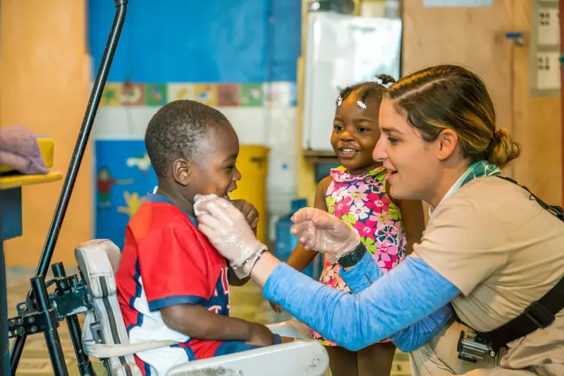 a healthcare worker examining a child