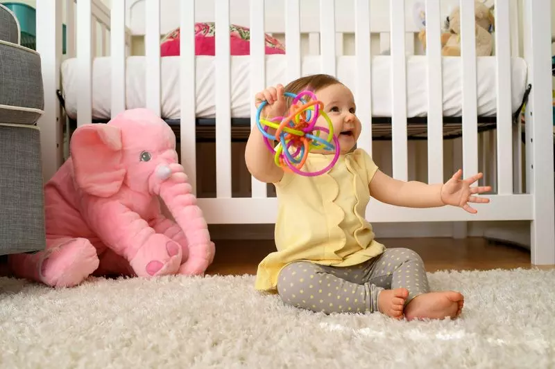 Baby plays with her toy at home