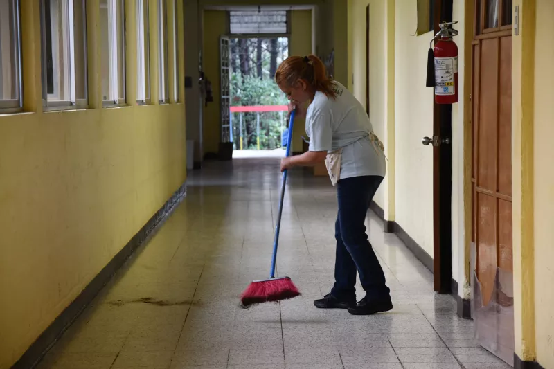 An AdventHealth team member sweeps the floor at the malnutrition center in Guatemala.