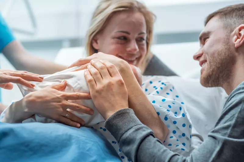 A happy family celebrates their new baby.