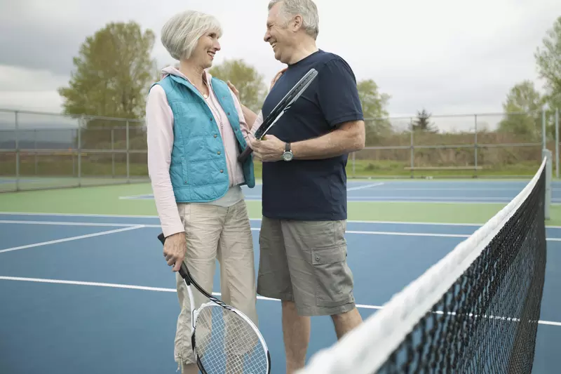 Senior couple playing tennis