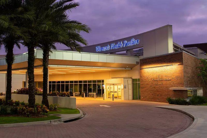 AdventHealth Tampa's Women's Health Pavilion entrance at night