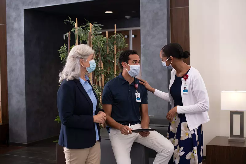 Three AdventHealth workers in a discussion