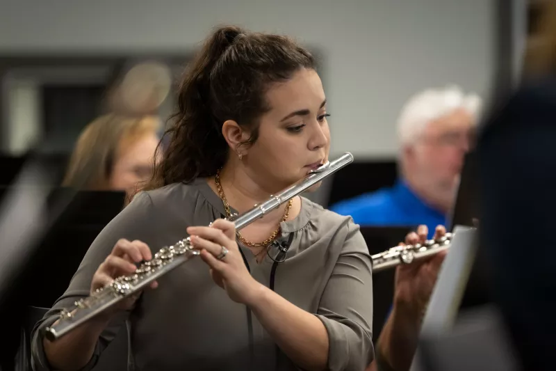 Erica Kopp practices with the AdventHealth employee orchestra.