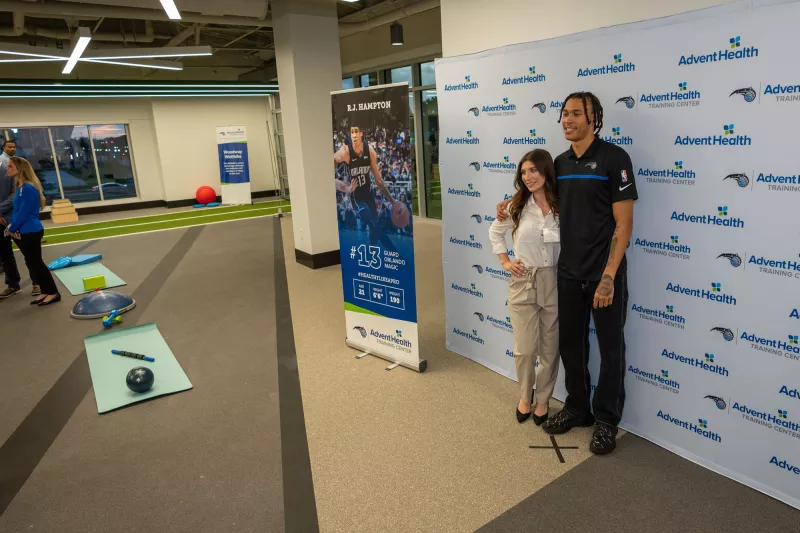 Guest poses with Orlando Magic player, R.J. Hampton, inside the Sports Medicine and Rehab facility within the AdventHealth Training Center 
