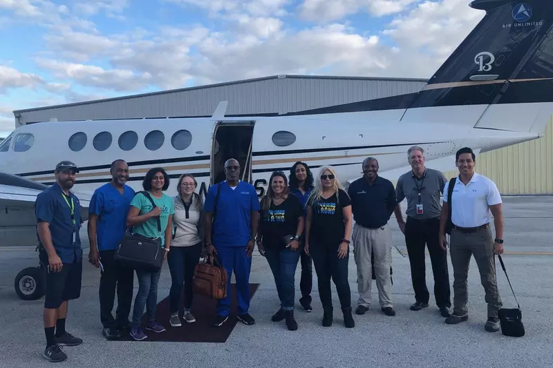 Bahamas recovery efforts team in front of airplane