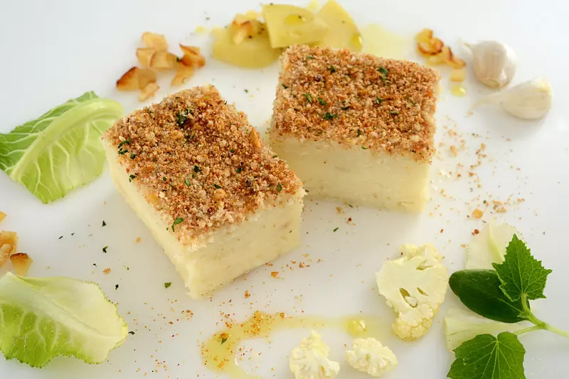 Pureed cauliflower molded into a cube with a crispy breadcrumb topping
