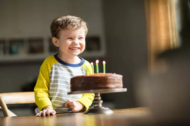 Child excited for his birthday cake