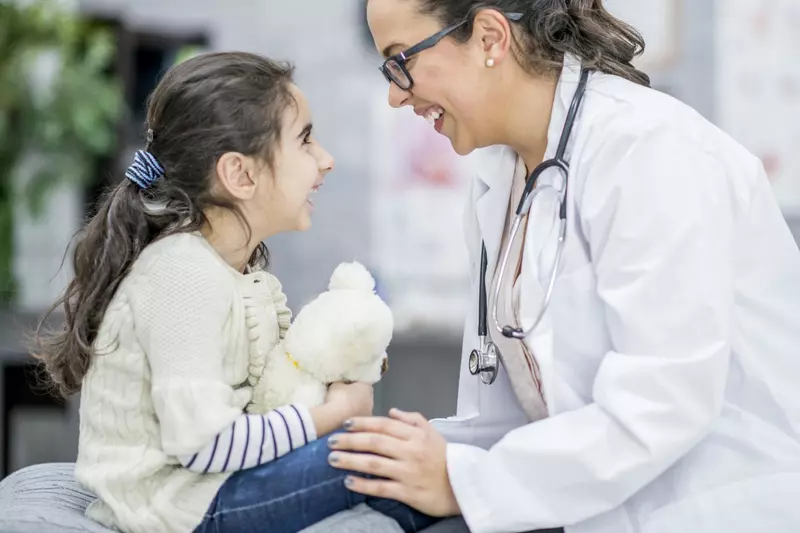 Child smiling at her doctor