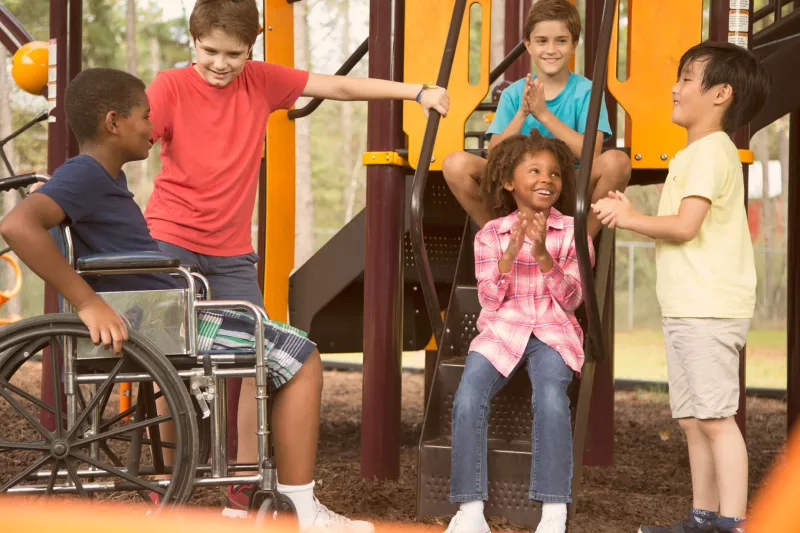 A group of kids talking at the playground