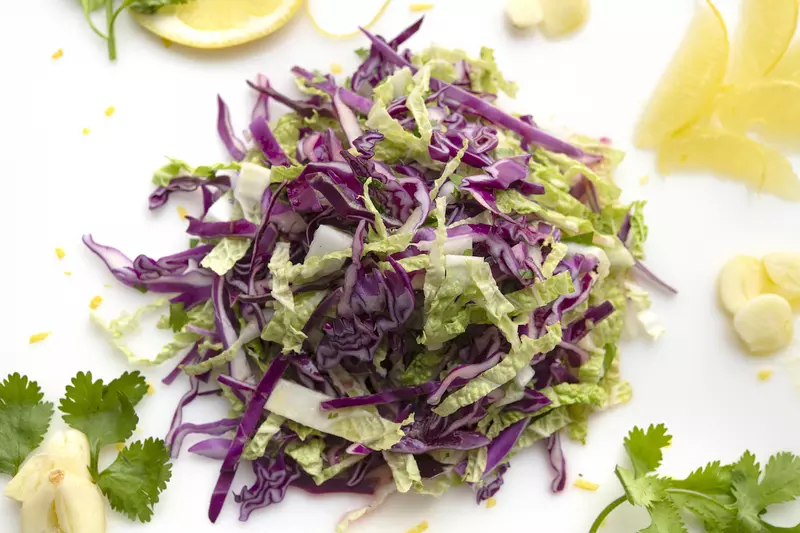 Mound of napa cabbage salad with cilantro garnish