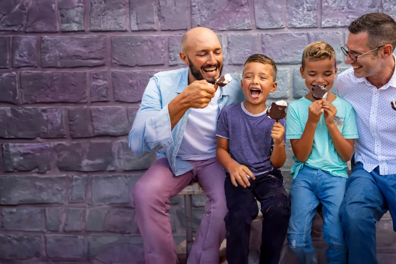 A Couple Sits with Their Children While Eating Ice Cream