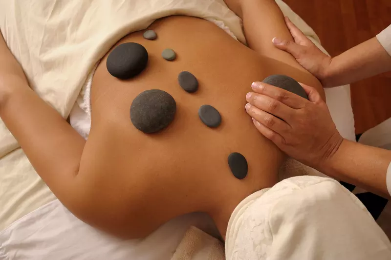 Woman getting a hot rock massage.