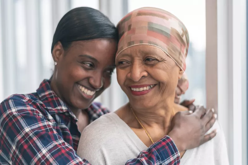 An Adult Daughter Hugs Her Senior Mom