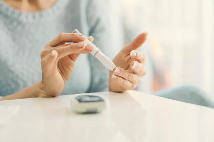 A Close Up of a Senior Person Checking Their Glucose with a Monitor