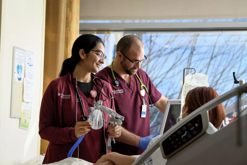 two uChicago Medicine AdventHealth Nurses caring for a patient