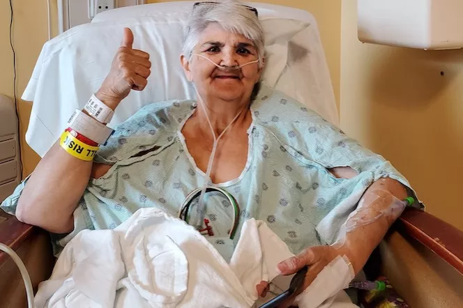 Patient Carol Dunn giving a thumbs up after her surgery.