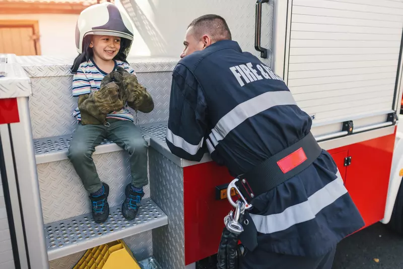 Smiling child with firefighter