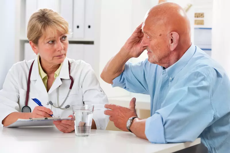 A man discusses his symptoms with his doctor.
