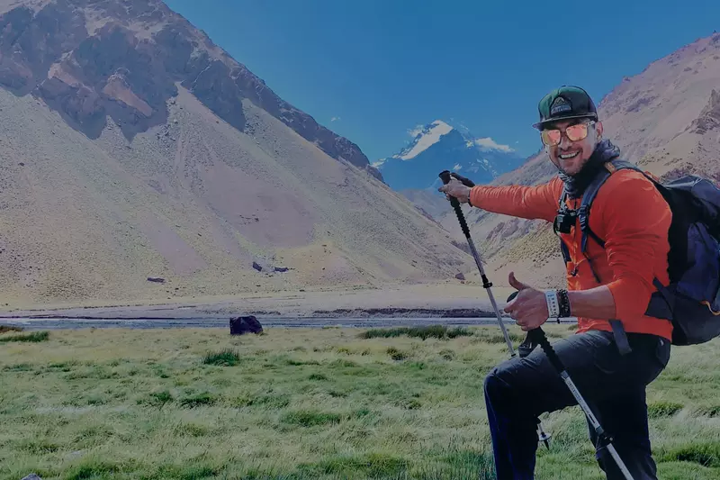 Man giving a thumbs up during a mountain climbing hike