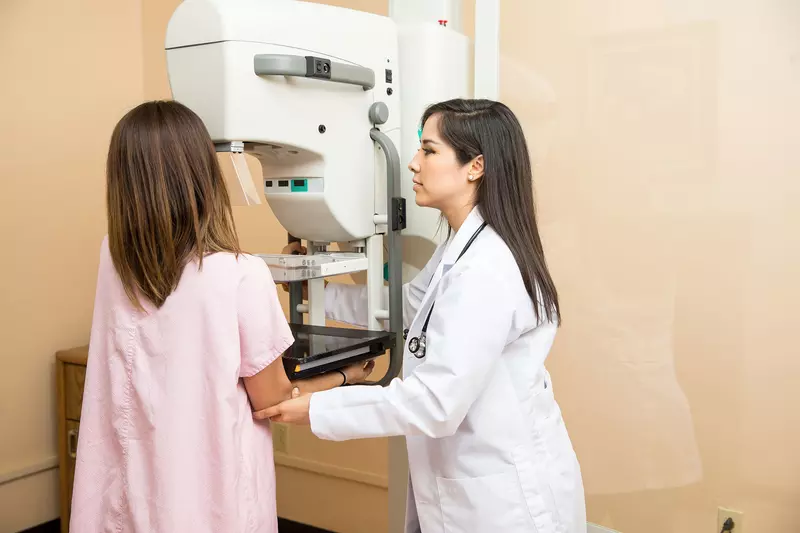 Woman having a mammogram.
