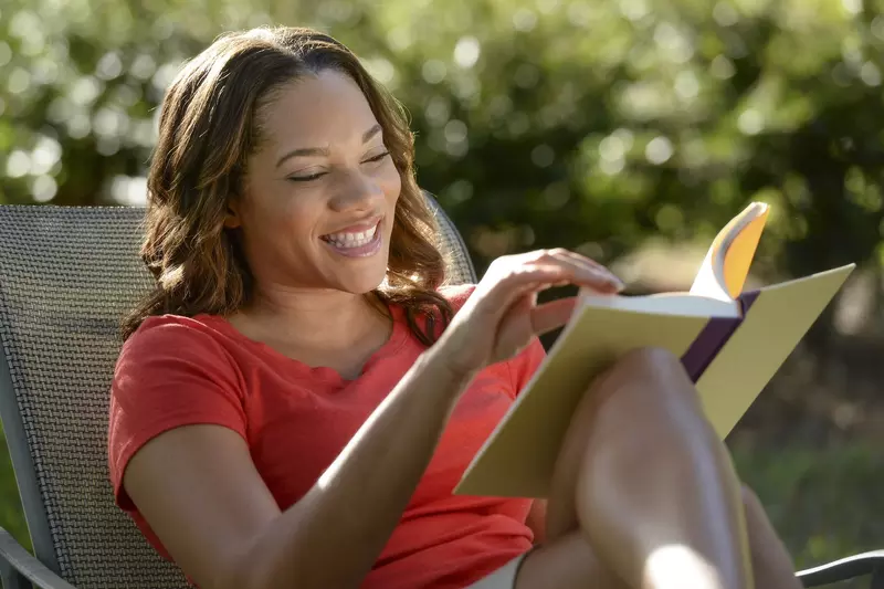 A woman reading outdoors.