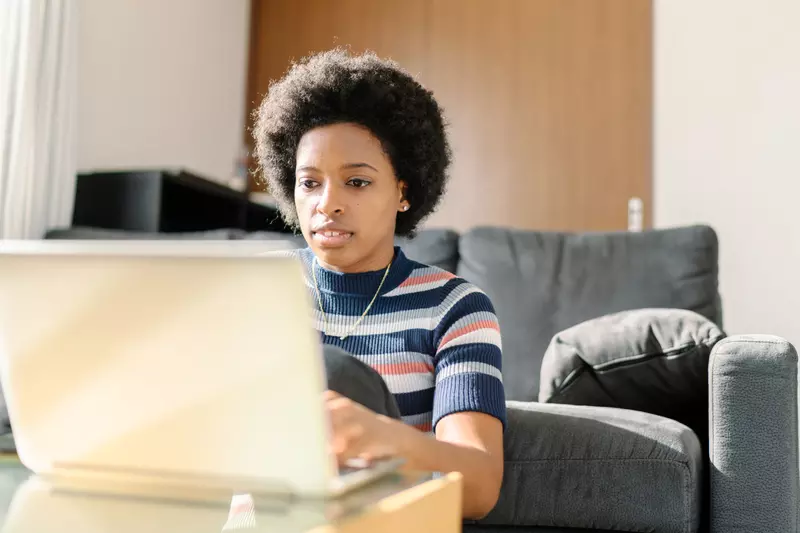 A woman doing a task on her laptop