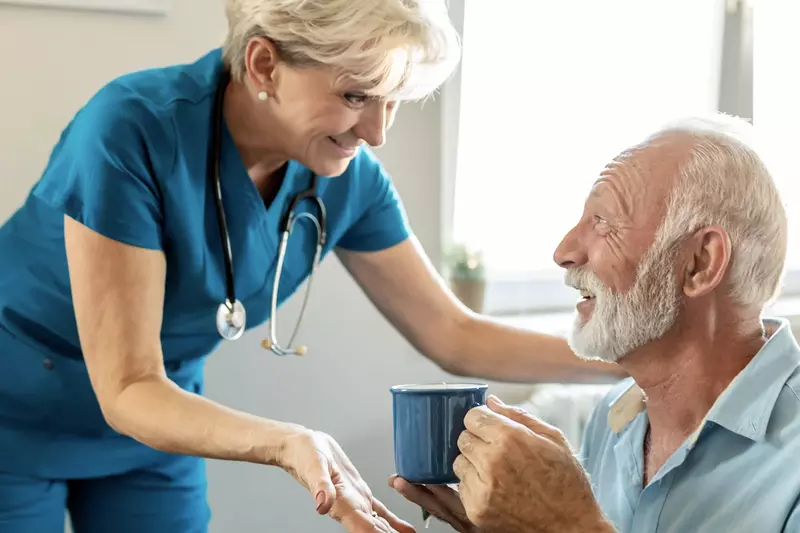 Female nurse talking with a male hospice patient.