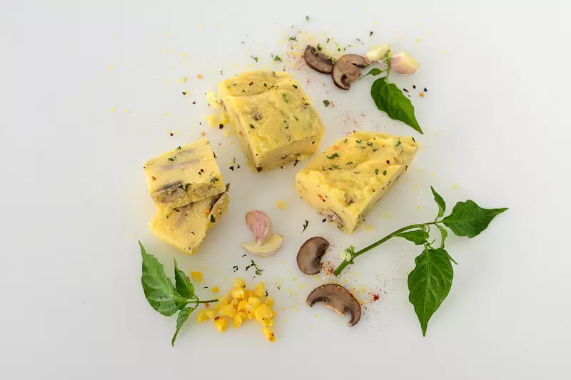 sliced squares of polenta with mushrooms and herbs