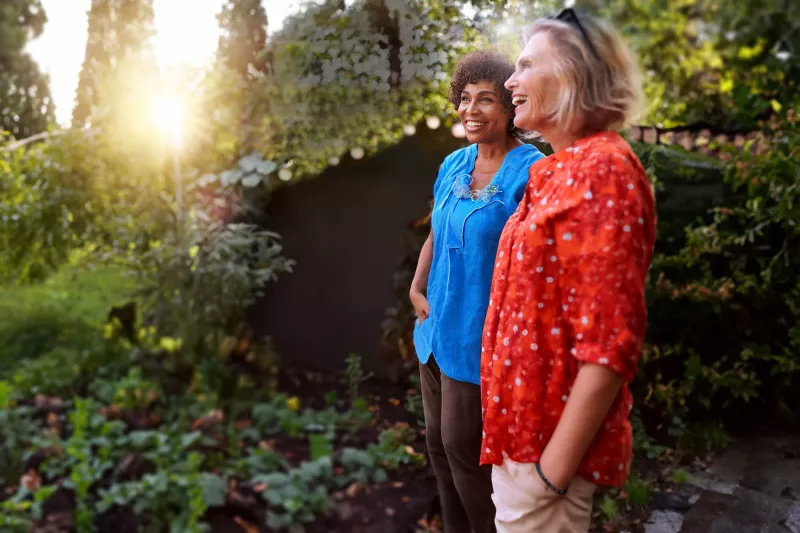 Retirement-aged women standing in garden