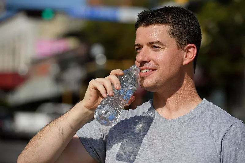 Man drinking water during a workout.