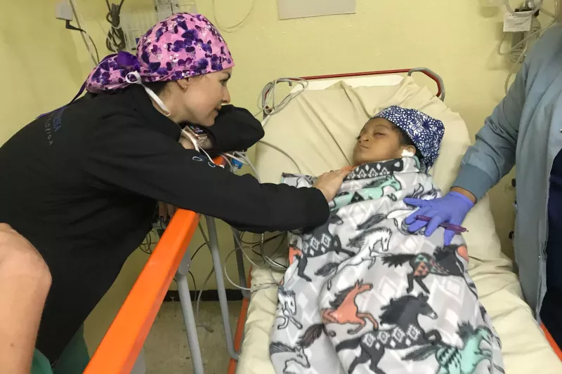 a doctor checks on a child