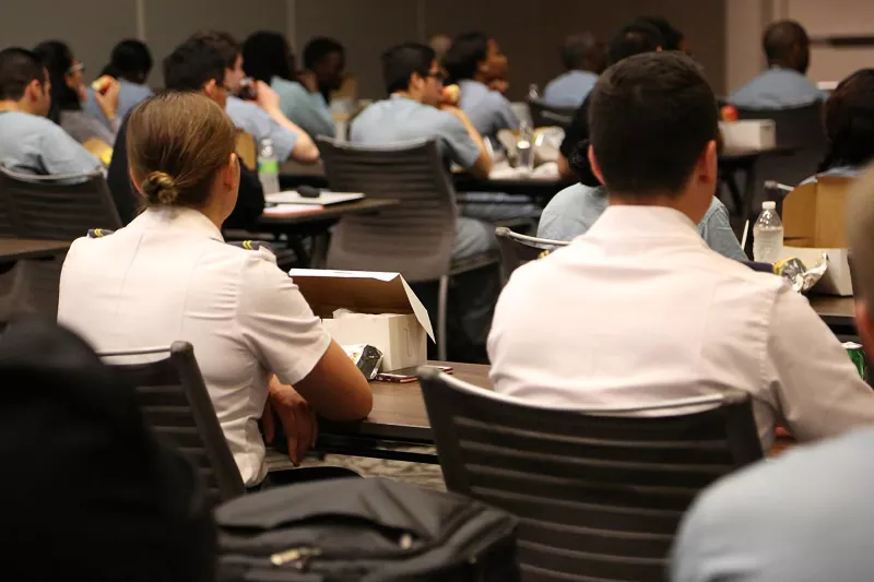 Professionals attending a conference in a Nicholson Center Eduction Center room.